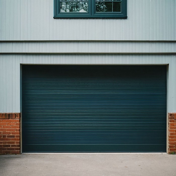 Experienced technicians repairing a garage door spring.