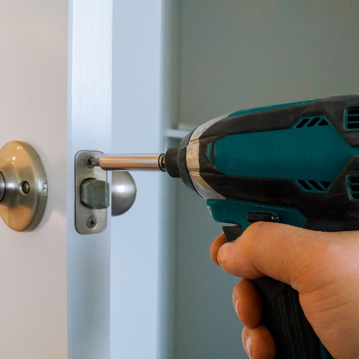 Technician using advanced tools to unlock a door
